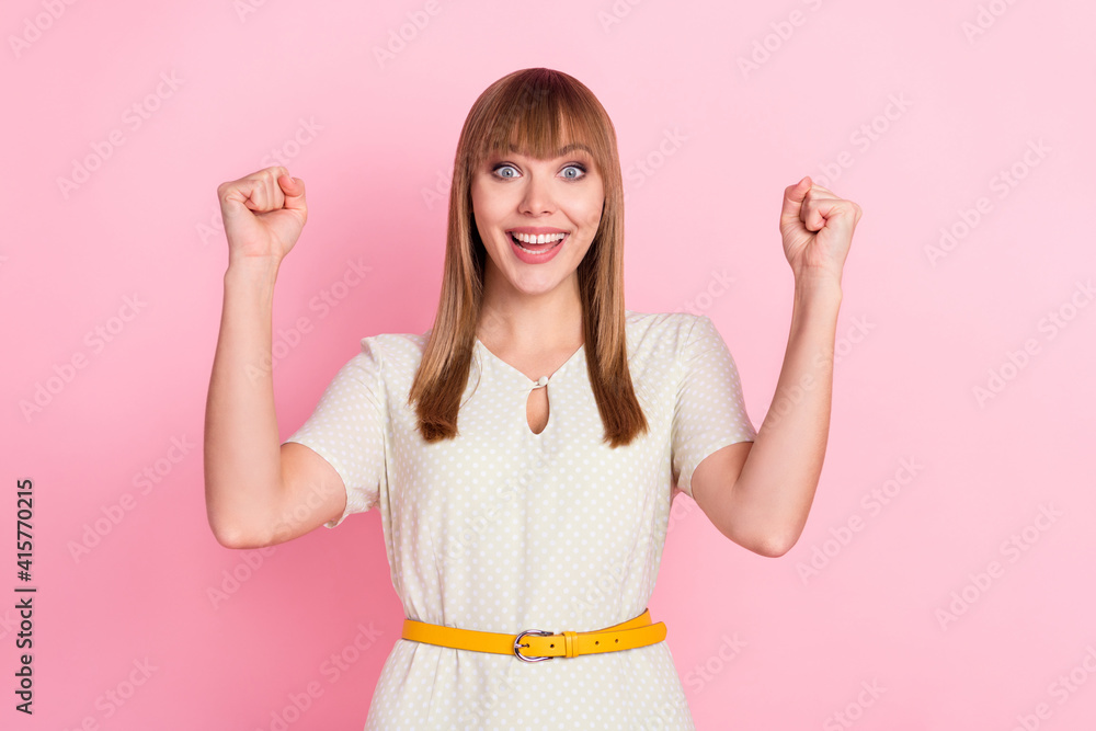 Poster portrait of attractive cheerful girl rejoicing good news having fun isolated over pink pastel color 