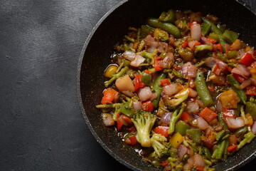 Fried vegetable mixture of carrots, broccoli ,peppers, red onion and peas. Healthy food