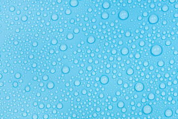 Water drops on blue background texture. Backdrop glass covered with drops of water. bubbles in water