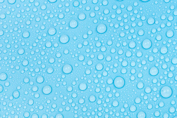 Water drops on blue background texture. Backdrop glass covered with drops of water. bubbles in water