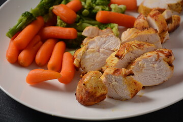 Grilled chicken fillet and vegetables broccoli and carrots boiled