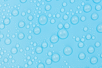 Water drops on blue background texture. Backdrop glass covered with drops of water. bubbles in water
