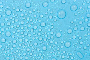 Water drops on blue background texture. Backdrop glass covered with drops of water. bubbles in water