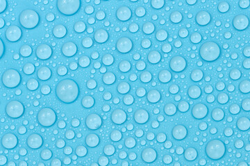 Water drops on blue background texture. Backdrop glass covered with drops of water. bubbles in water