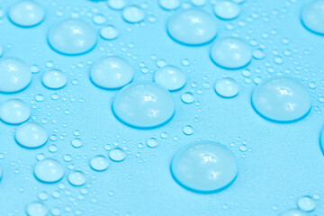 Water drops on blue background texture. Backdrop glass covered with drops of water. bubbles in water