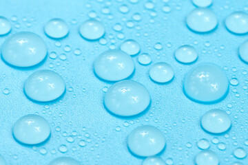 Water drops on blue background texture. Backdrop glass covered with drops of water. bubbles in water