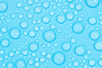 Water drops on blue background texture. Backdrop glass covered with drops of water. bubbles in water
