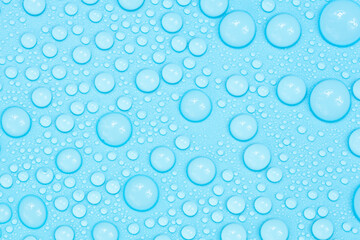 Water drops on blue background texture. Backdrop glass covered with drops of water. bubbles in water