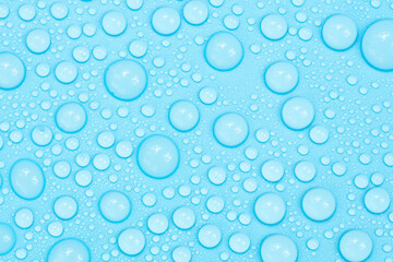 Water drops on blue background texture. Backdrop glass covered with drops of water. bubbles in water