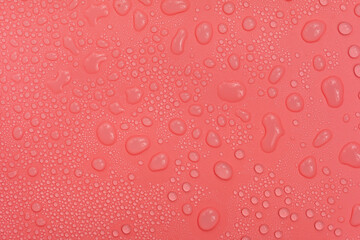 Water drops on red background texture. backdrop glass covered with drops of water.  bubbles in water