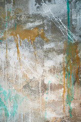 The wall with flowing gold and turquoise paint, the main tone is gray.Texture with a place for text.