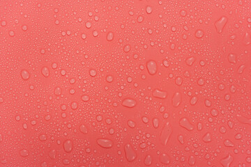 Water drops on red background texture. backdrop glass covered with drops of water.  bubbles in water