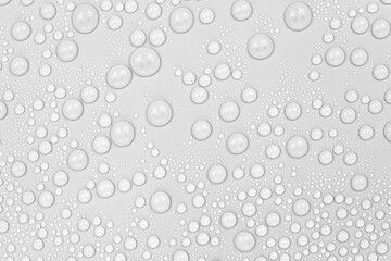 Water drops on white background texture. backdrop glass covered with drops of water.  bubbles in water