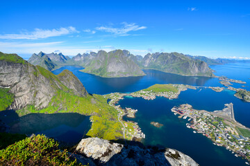 Stunning view point of mountains and blue sea at Reinebringen, Lofoten islands. Scenery of Reine fishing village. One of most popular hiking trails in North of Norway. Nature background
