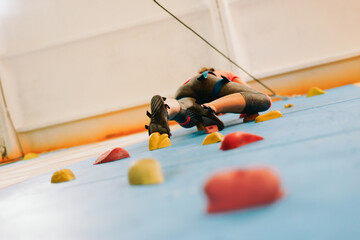 Rocks on climbing wall. Fitness, extreme sport, bouldering, people and healthy lifestyle concept -...