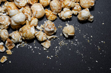 Caramel popcorn on black backgroundю