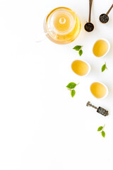 Tea ceremony concept. Hot and dry tea in teapot and cups, top view