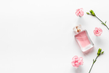 Top view of perfume bottle and flowers. Flat lay