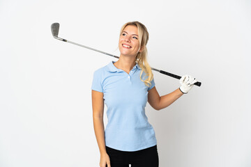 Young Russian woman isolated on white background playing golf and looking up while smiling
