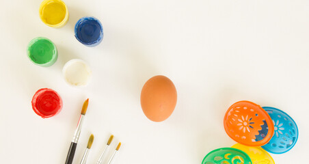 Easter egg, paints, brushes and stencils for drawing on a white background. Preparing for Easter....