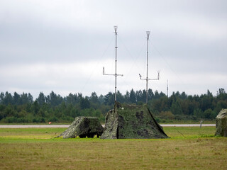 Military tent with radio and antenna camouflage net