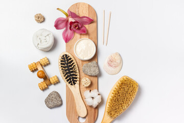 Spa care. Items for spa treatments made of natural materials, scrub, soap with extracts of herbs and flowers. Layout on a white background