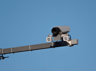 Security camera on blue sky background