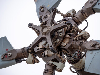 Fototapeta premium The mechanism of screws military helicopter on the background of blue sky, a close-up