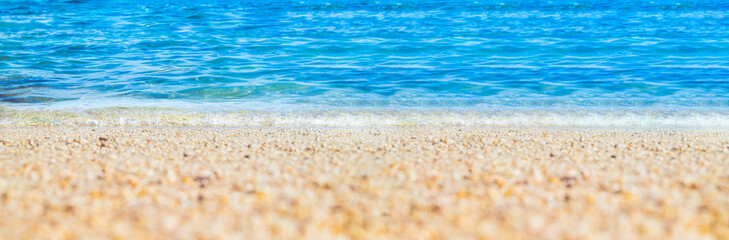 Fototapeta na wymiar summer beach low angle view background.Close up wave of blue sea on sand beach seashore