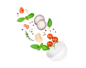 Tomato, basil, spices, chili pepper, garlic fresh thyme, onion flying. Vegan diet food isolated on white. Falling into bowl, levitation fly. Creative concept