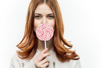 cute red haired woman with lollipop behold street delight sweets light background