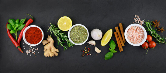 Colorful various herbs and spices for cooking on dark background, banner