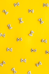 Pasta pattern - colored farfalle, top view. Italian food background