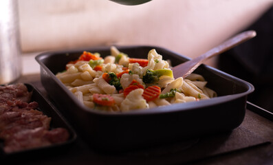 preparation of pasta with vegetables in the pan. healthy vegan food