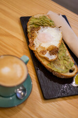 Breakfast of coffee and avocado and egg toast