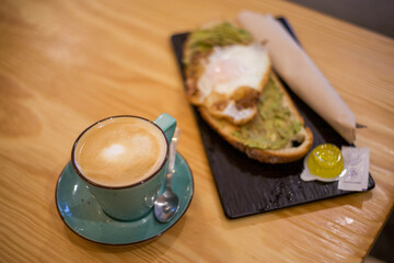 Breakfast of coffee and avocado and egg toast