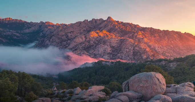 Rocky mountain peak La Pedriza sunrise with low clouds timelapse with beautiful light