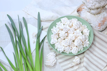 Delicious appetizing Meringue Pavlovas. Homemade meringues. French dessert, sweet food made by baking a mixture of stiffly beaten egg whites and sugar until crisp. Texture background, view from above