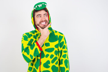 Fototapeta premium young caucasian man wearing a pyjama standing against white wall Thinking worried about a question, concerned and nervous with hand on chin.