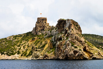 View of ruins of Cabrera Castle and coastal cliffs