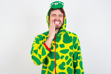 Fototapeta premium young caucasian man wearing a pajama standing against white wall touching mouth with hand with painful expression because of toothache or dental illness on teeth.