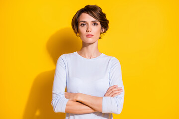 Photo of strict self-assured lady crossed arms look camera wait wear white shirt isolated yellow color background