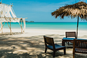 Table and chair at tropical summer beach.