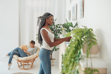 African american girl cleaning the room and looking positive