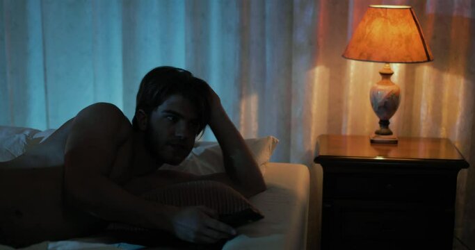 Ragazzo guarda la tv in camera da letto