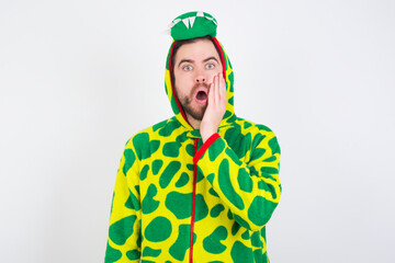 Fototapeta premium Shocked young caucasian man wearing a pajama standing against white background looks with great surprisment being very stunned, astonished with unexpected news, Facial expressions concept.