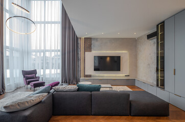 Living room in luxury flat. Panoramic window. Cozy furniture.