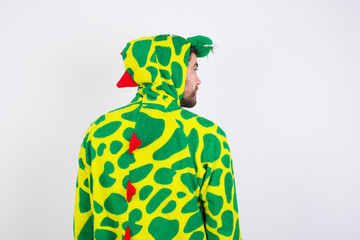 The back side view of a young caucasian man wearing a pajama standing against white background. Studio Shoot.