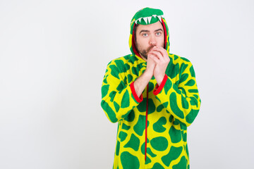 young caucasian man wearing a pajama standing against white background freezing, warming up hands, feels cold as she ran from office to buy cup of coffee.