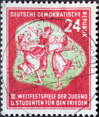 GERMANY, DDR - CIRCA 1951 : a postage stamp from Germany, GDR showing a folk dance group. III. World Festival of Youth and Students for Peace